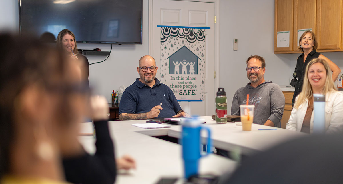 dr-matthew-ramsey-talking-to-community-living-managers-in-meeting